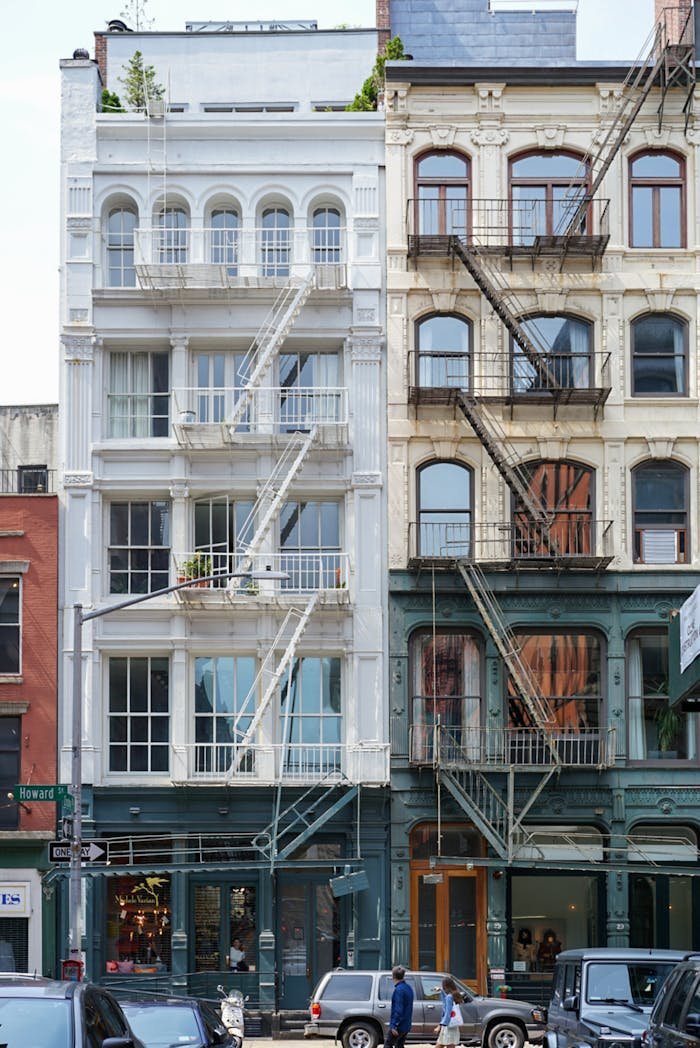 Charming urban street view of vintage buildings with iconic fire escapes.